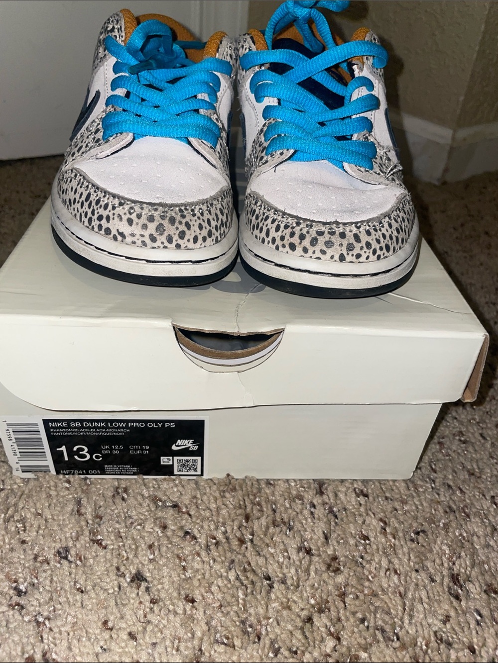 Nike Kids White Sneakers with Bright Blue Laces and Speckled Accents